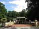 Beautiful home with brick courtyard, retaining wall with pillar accents, and lush surrounding landscape at 5523 Bahia Mar Cir, Stone Mountain, GA 30087