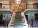 Stately foyer with dual staircases, wood railing and carpeting leading to the second level at 5523 Bahia Mar Cir, Stone Mountain, GA 30087