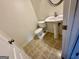 A cozy half-bath features vinyl flooring, a white pedestal sink, and toilet at 6367 Ellenwood Drive, Rex, GA 30273
