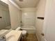 Bathroom highlighting a shower-tub combo, white fixtures, and neutral-toned tile flooring at 6367 Ellenwood Drive, Rex, GA 30273