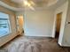 Bedroom featuring carpet flooring, natural lighting, and a view of the en-suite bath and walk-in closet at 6367 Ellenwood Drive, Rex, GA 30273