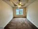 Bright bedroom with a ceiling fan, neutral walls and carpet, and a large window providing lots of light at 6367 Ellenwood Drive, Rex, GA 30273