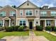 Inviting townhome showcasing manicured landscaping, a symmetrical design, and a welcoming front entrance at 6367 Ellenwood Drive, Rex, GA 30273