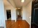 Inviting hallway featuring hardwood floors and neutral walls leading to the kitchen and other rooms at 6367 Ellenwood Drive, Rex, GA 30273