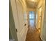Hallway with carpet, a view of other rooms and multiple doors providing access at 6367 Ellenwood Drive, Rex, GA 30273