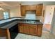 Kitchen area with oak cabinets, black appliances, and tile flooring at 6367 Ellenwood Drive, Rex, GA 30273