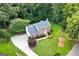 Aerial view of a beautiful brick home with a well-manicured lawn, mature landscaping, and a circular driveway at 150 Tramore Trce, Tyrone, GA 30290