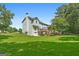 Spacious backyard featuring a large deck, lush green lawn, and mature trees, perfect for outdoor living at 150 Tramore Trce, Tyrone, GA 30290