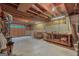 Unfinished basement with concrete floor, exposed ceiling, and workbench at 150 Tramore Trce, Tyrone, GA 30290