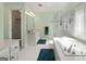 Bright bathroom featuring a soaking tub, glass shower, and white cabinets at 150 Tramore Trce, Tyrone, GA 30290