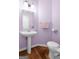 Powder bathroom with pedestal sink, wooden floors and decorative accents at 150 Tramore Trce, Tyrone, GA 30290