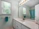 Bathroom with a single sink vanity, window, and tile floor at 150 Tramore Trce, Tyrone, GA 30290
