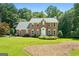 Charming brick two-story home with a manicured front lawn and mature trees, offering classic curb appeal at 150 Tramore Trce, Tyrone, GA 30290