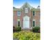 Close-up of the home's front entrance, showcasing its brick facade and white front door at 150 Tramore Trce, Tyrone, GA 30290