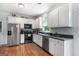 Functional kitchen featuring stainless steel appliances, white cabinets, and ample countertop space at 150 Tramore Trce, Tyrone, GA 30290