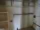 The unfinished basement offers built-in shelves and space for customization, perfect for storage or a workshop area at 3048 Haverford Se Ln, Marietta, GA 30067