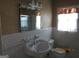 Classic bathroom with a pedestal sink, large mirror, and natural light at 3048 Haverford Se Ln, Marietta, GA 30067