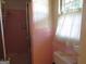 Bathroom featuring pink tile, a shower, and a window with a white curtain at 3048 Haverford Se Ln, Marietta, GA 30067