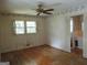 Spacious bedroom featuring hardwood floors, ceiling fan, and access to an adjacent bathroom at 3048 Haverford Se Ln, Marietta, GA 30067