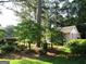 A cozy single-story home nestled among mature trees and lush landscaping, offering a private setting at 3048 Haverford Se Ln, Marietta, GA 30067