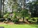 A cozy single-story home nestled among mature trees and lush landscaping, offering a private setting at 3048 Haverford Se Ln, Marietta, GA 30067