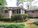 Charming brick home with a screened-in porch and a well-maintained brick walkway surrounded by lush landscaping at 3048 Haverford Se Ln, Marietta, GA 30067