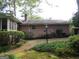The house shows a brick exterior, a well-kept yard, and a classic street lamp that matches the house's style at 3048 Haverford Se Ln, Marietta, GA 30067