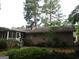 Brick house features a screened-in porch and is surrounded by lush landscaping, providing a private and serene outdoor space at 3048 Haverford Se Ln, Marietta, GA 30067