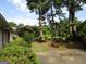 View of the front yard with mature trees, lush landscaping and a walkway to the home at 3048 Haverford Se Ln, Marietta, GA 30067