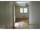 Hallway view into a bedroom featuring hardwood floors and natural light from a window at 3048 Haverford Se Ln, Marietta, GA 30067