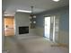 Inviting living room features a brick fireplace, modern chandelier, and sliding glass door at 3048 Haverford Se Ln, Marietta, GA 30067