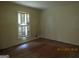 Bright living room with hardwood floors and large windows, creating a warm and inviting space at 3048 Haverford Se Ln, Marietta, GA 30067