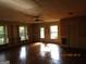 Spacious living room with built-in shelving, large windows, and hardwood floors at 3048 Haverford Se Ln, Marietta, GA 30067