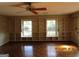 Bright living room featuring hardwood floors, a ceiling fan, and built in shelving at 3048 Haverford Se Ln, Marietta, GA 30067