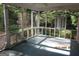View of the screened porch and backyard featuring mature trees and landscaping at 3048 Haverford Se Ln, Marietta, GA 30067