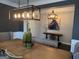 Stylish dining room featuring a large wooden table, modern lighting, and sophisticated decor with a horse painting at 2920 Prestwood Dr, Cumming, GA 30040