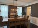 Elegant dining room with a wooden table, modern chandelier, and neutral-toned walls, perfect for entertaining at 2920 Prestwood Dr, Cumming, GA 30040