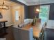 Well-lit dining room with a wooden table, modern light fixtures, and views to the exterior and side yard at 2920 Prestwood Dr, Cumming, GA 30040
