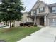 Well-maintained home showcasing lush landscaping, a driveway, and a mix of brick and siding on the facade at 2920 Prestwood Dr, Cumming, GA 30040