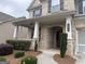 Inviting front porch featuring brick columns and manicured shrubs, with a clear view of the front door and house number at 2920 Prestwood Dr, Cumming, GA 30040