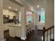 Open-concept kitchen with white cabinetry, granite countertops, and stainless steel appliances, seamlessly connected to the living space at 2920 Prestwood Dr, Cumming, GA 30040