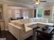 Spacious living room with large sectional sofa and view into the dining room at 2920 Prestwood Dr, Cumming, GA 30040