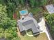 Aerial view of a home with a backyard pool and mature trees at 65 Cold Harbor Ct, Sharpsburg, GA 30277