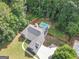 Overhead shot of a well-maintained home with pool and partially fenced backyard at 65 Cold Harbor Ct, Sharpsburg, GA 30277