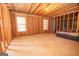 Unfinished basement with exposed framing, a concrete floor, insulation, and two windows at 65 Cold Harbor Ct, Sharpsburg, GA 30277