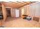 Unfinished basement with exposed framing, concrete floors, a utility access, and a vintage refrigerator at 65 Cold Harbor Ct, Sharpsburg, GA 30277