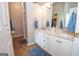Well-lit bathroom features a double vanity with marble countertops and a glass shower at 65 Cold Harbor Ct, Sharpsburg, GA 30277