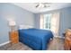 This bedroom boasts vinyl floors, natural light, and a ceiling fan at 65 Cold Harbor Ct, Sharpsburg, GA 30277
