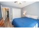 Comfortable bedroom includes vinyl floors, a ceiling fan, and double sliding-door closet at 65 Cold Harbor Ct, Sharpsburg, GA 30277