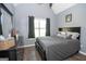 Bedroom featuring vaulted ceiling, wood-look floors, a dresser, and a large bed with decorative pillows at 65 Cold Harbor Ct, Sharpsburg, GA 30277